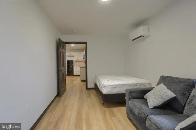 a bedroom with a bed and wooden floor