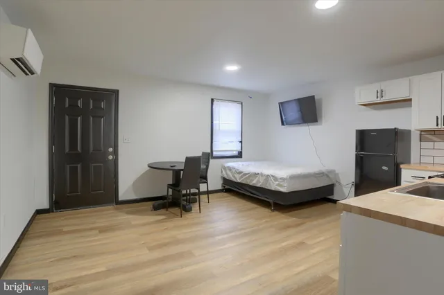 a bedroom with a bed and a tv