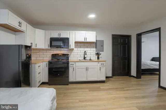 a kitchen with a refrigerator stove and microwave