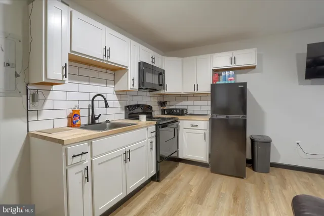a kitchen with a sink cabinets and stainless steel appliances