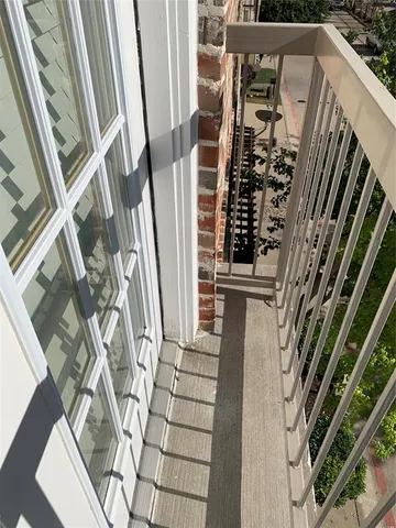 a view of a balcony with wooden floor