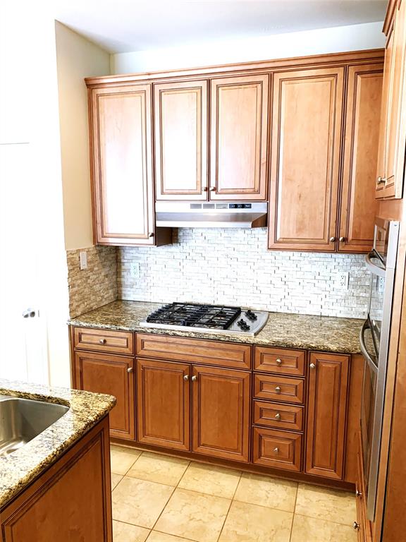 2106 Azure Pointe Richardson, TX 75080 - Photo 6 of 20 a kitchen with stainless steel appliances granite countertop a stove a sink and a microwave