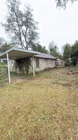 a backyard of a house with table and chairs