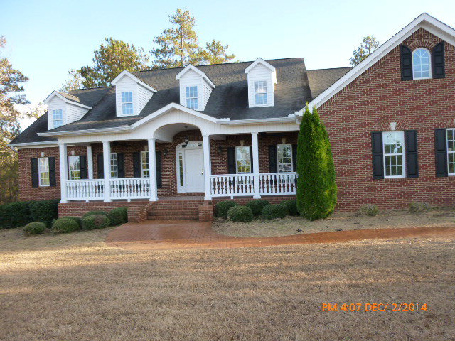 680 Jenkins Road Forsyth, GA 31029 - Photo 1 of 15 a front view of a house with a garden