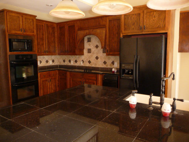 680 Jenkins Road Forsyth, GA 31029 - Photo 7 of 15 a kitchen with stainless steel appliances a stove a refrigerator and cabinets