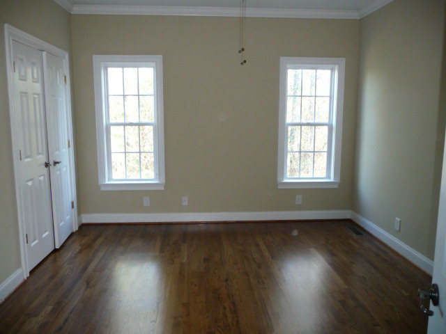 680 Jenkins Road Forsyth, GA 31029 - Photo 9 of 15 an empty room with wooden floor and windows
