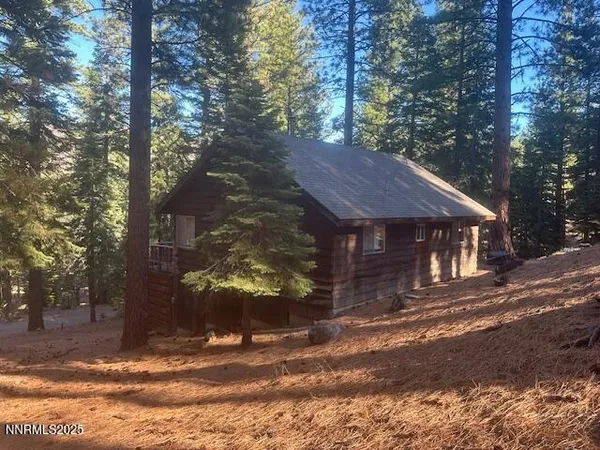 a view of a wooden house with a yard