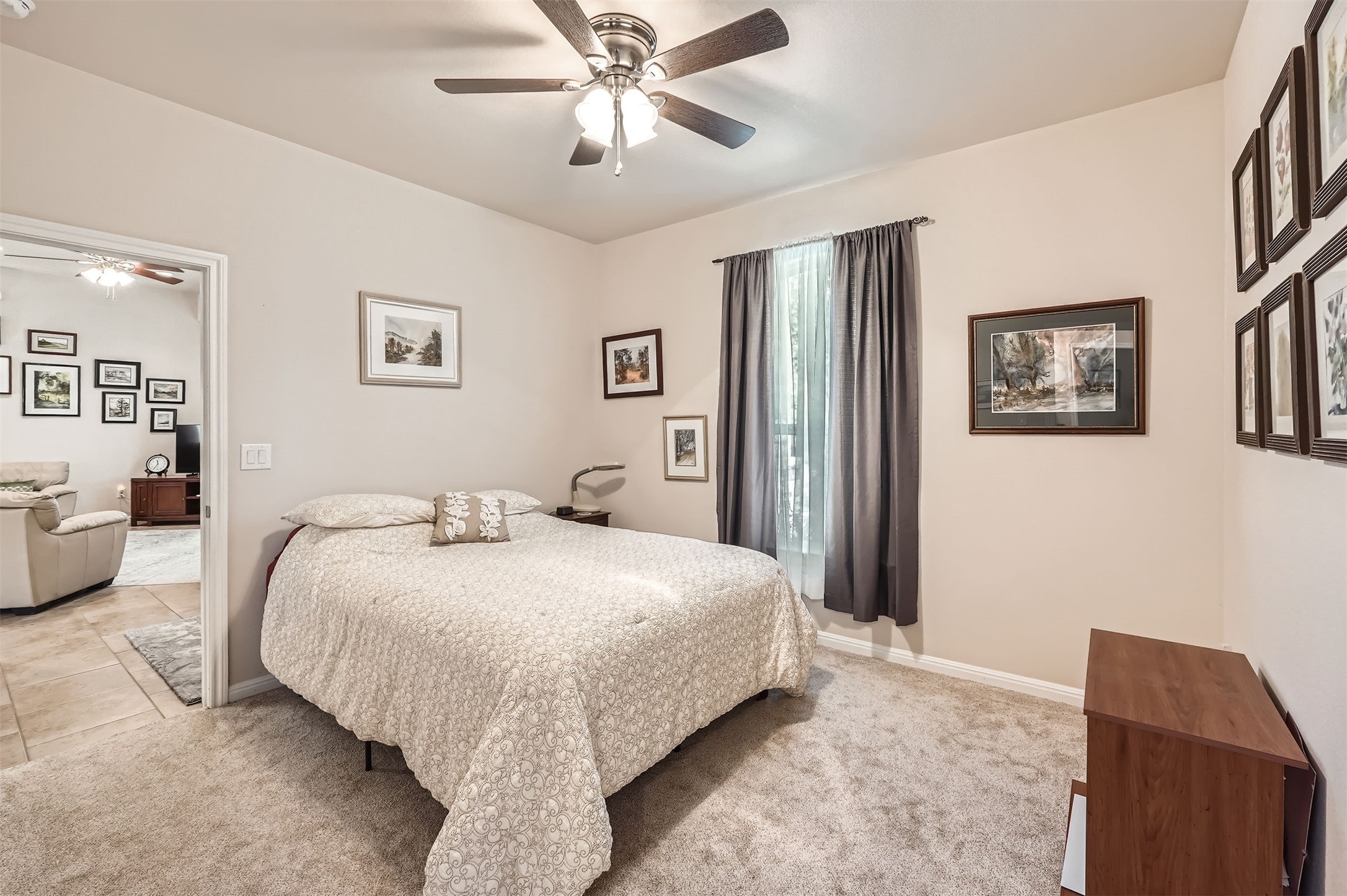 5501 Hitching Post Lago Vista, TX 78645 - Photo 22 of 26 a bedroom with a large bed and a chandelier