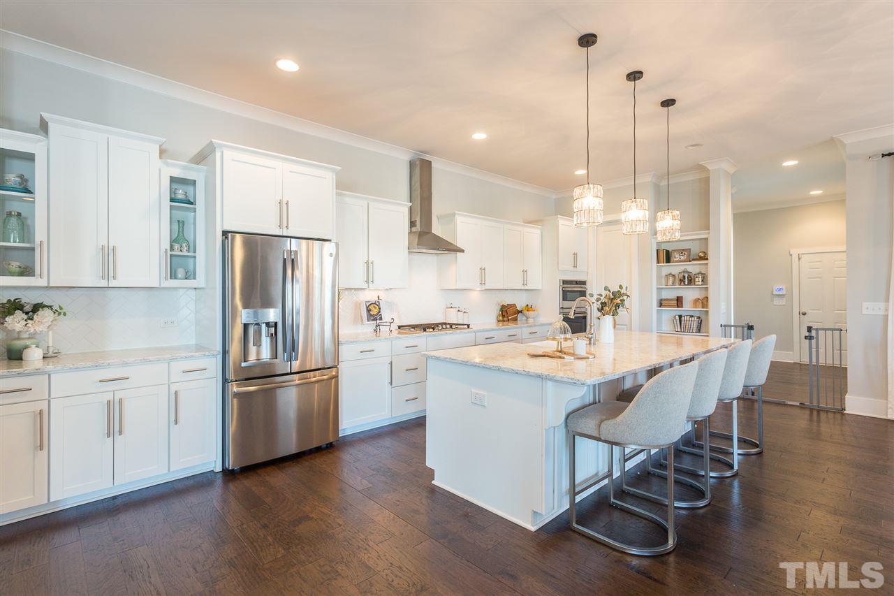 5410 Beckom Street Raleigh, NC 27616 - Photo 1 of 30 Custom kitchen with quartz counters, SS appliances, tons of storage and a custom farmhouse sink. Plus it has a HUGE walk in pantry with custom shelving!