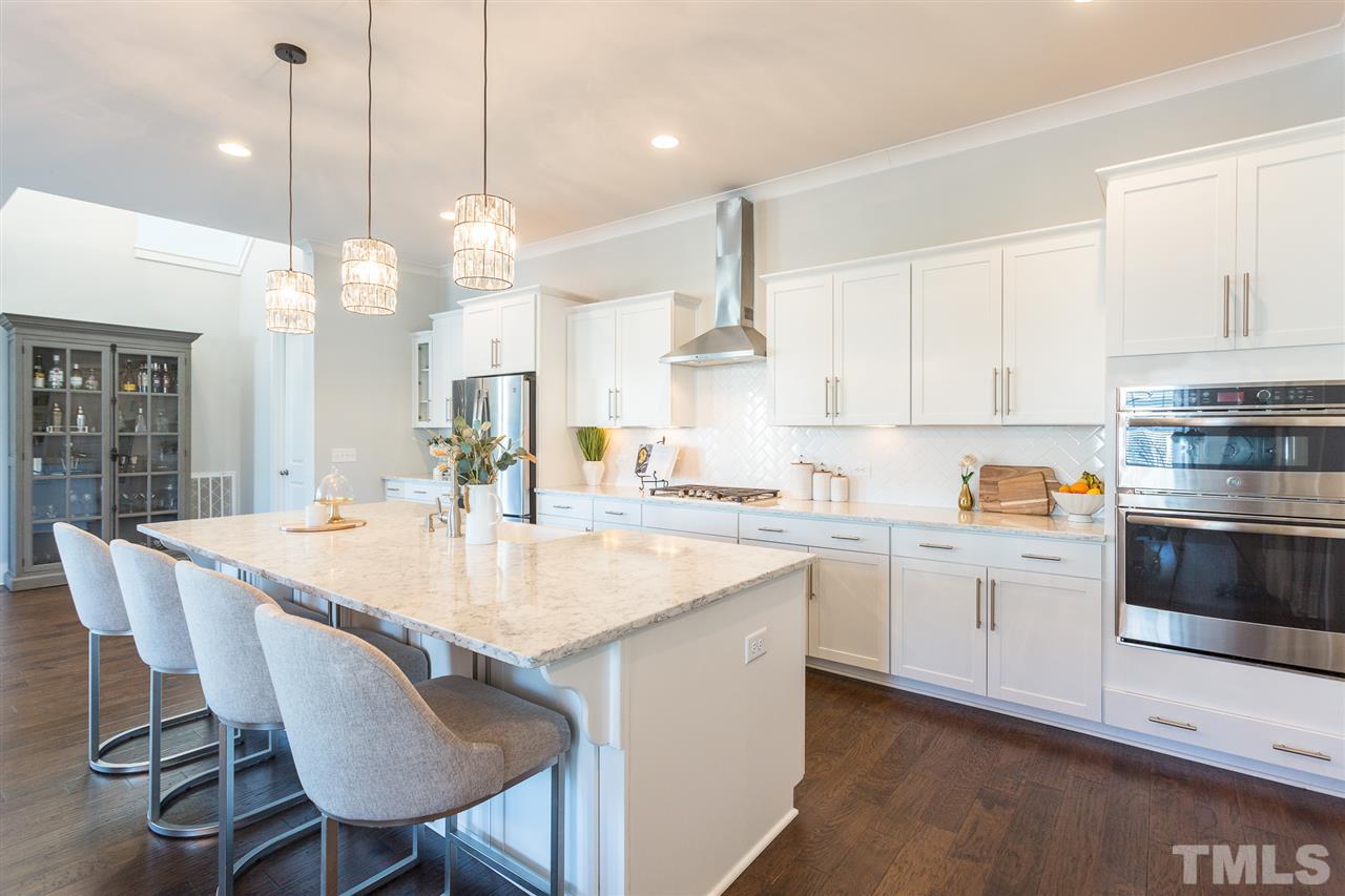 5410 Beckom Street Raleigh, NC 27616 - Photo 2 of 30 This island goes on for days- Lots of storage underneath and has an overhang that's perfect for day to day meals and hanging out.