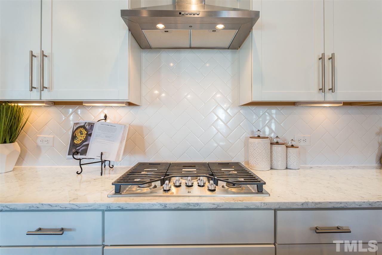 5410 Beckom Street Raleigh, NC 27616 - Photo 4 of 30 Custom tile backsplash. This home was designed to feel light and bright with high end finishes.