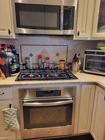 a close view of a stove top oven and cabinets