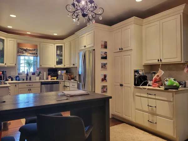 a kitchen with stainless steel appliances sink refrigerator and cabinets