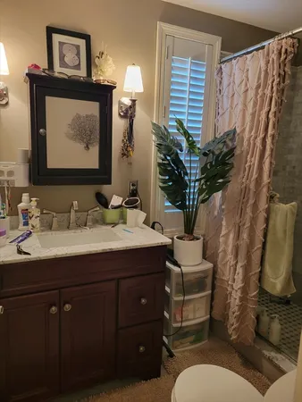 a bathroom with a toilet sink and mirror