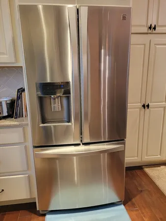 a view of a refrigerator with wooden floor