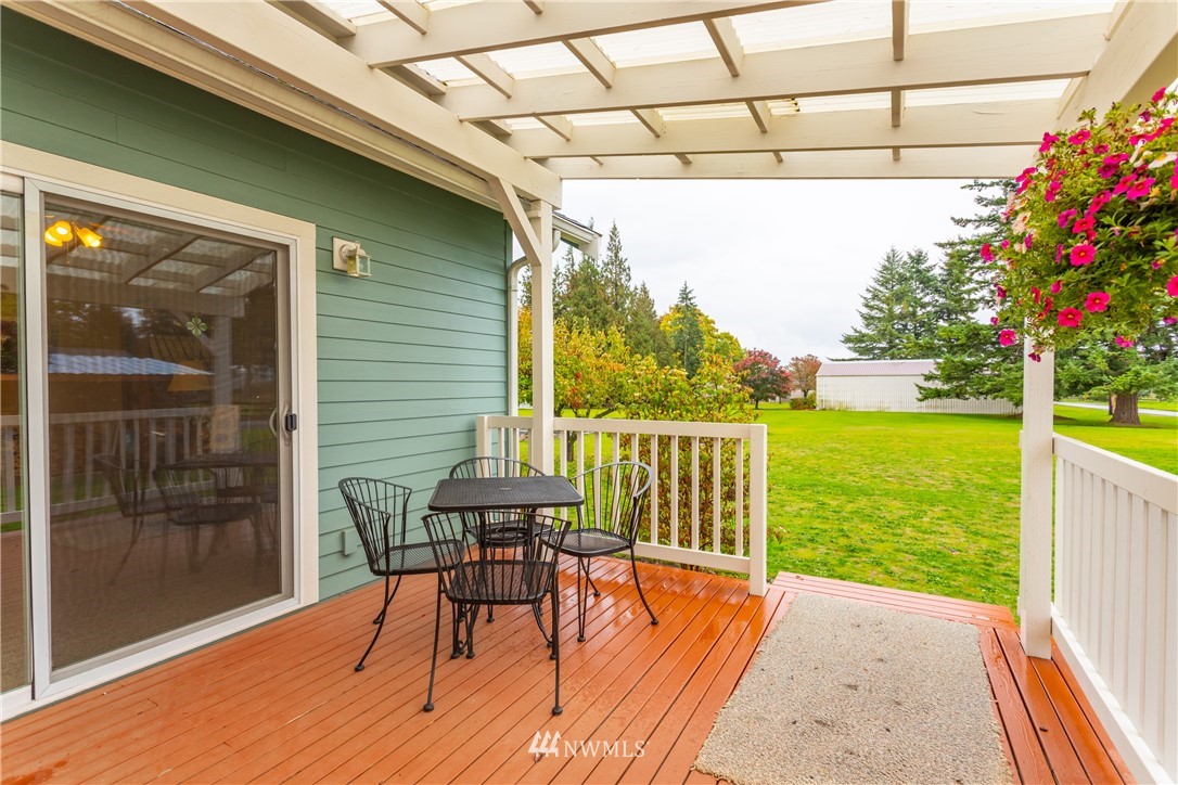 879 East Wiser Lake Road Lynden, WA 98264 - Photo 11 of 36 a balcony with chairs and wooden floor