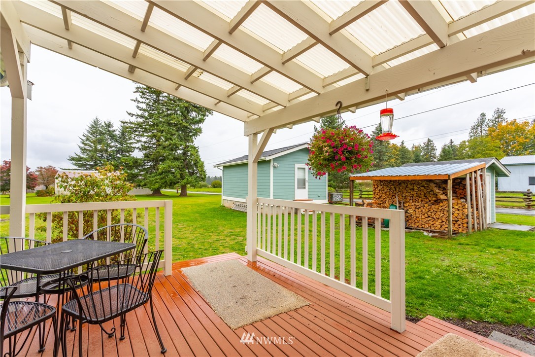 879 East Wiser Lake Road Lynden, WA 98264 - Photo 12 of 36 a view of a wooden chairs and table in the patio