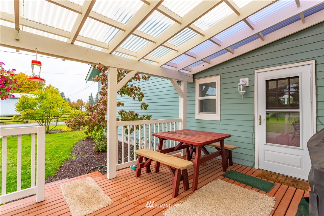 879 East Wiser Lake Road Lynden, WA 98264 - Photo 13 of 36 a backyard of a house with wooden floor and outdoor seating