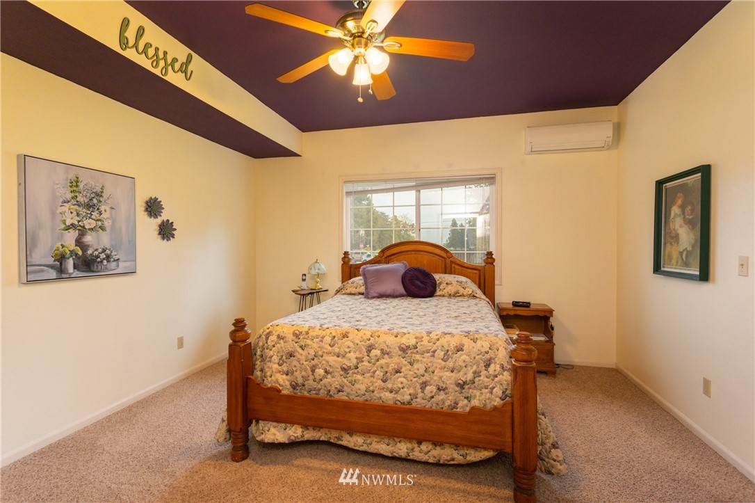 879 East Wiser Lake Road Lynden, WA 98264 - Photo 15 of 36 a bedroom with a bed and a chandelier