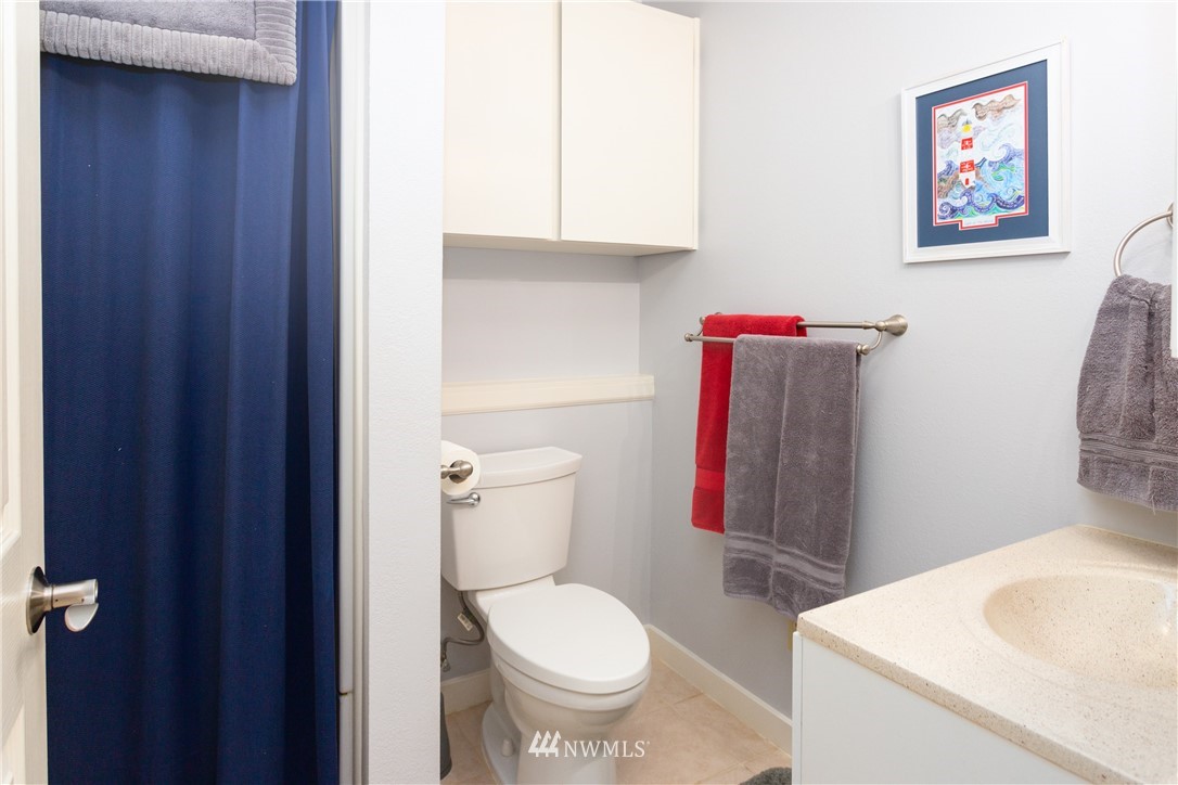 879 East Wiser Lake Road Lynden, WA 98264 - Photo 24 of 36 a white toilet sitting next to a bathroom sink and vanity