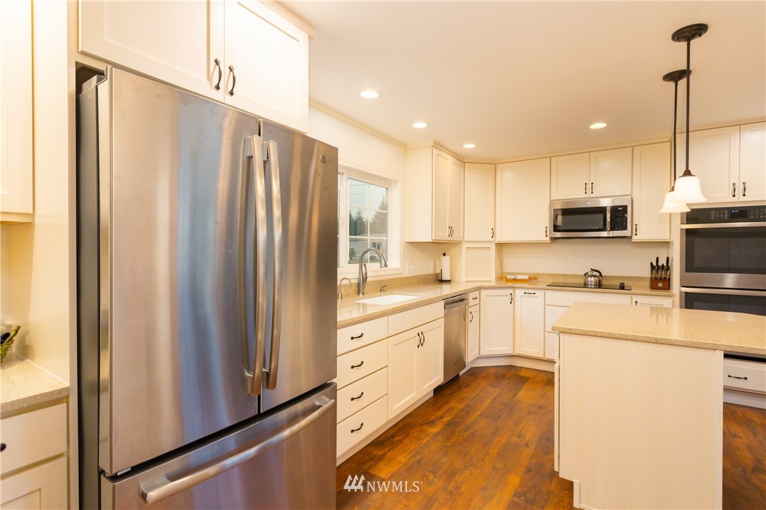 879 East Wiser Lake Road Lynden, WA 98264 - Photo 5 of 36 a kitchen with stainless steel appliances a refrigerator sink and microwave