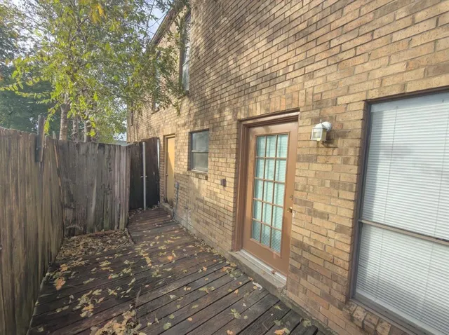 a view of a pathway with a wooden fence