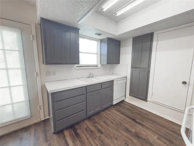a view with cabinets wooden floor and a window