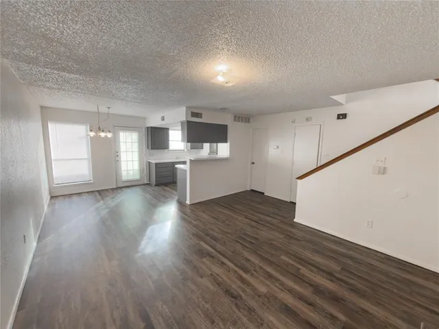 a view of a kitchen with wooden floor and a sink