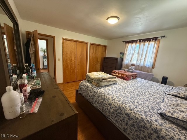 4669 Mars Road Uniontown, OH 44685 - Photo 24 of 31 Bedroom with wood finished floors and multiple closets