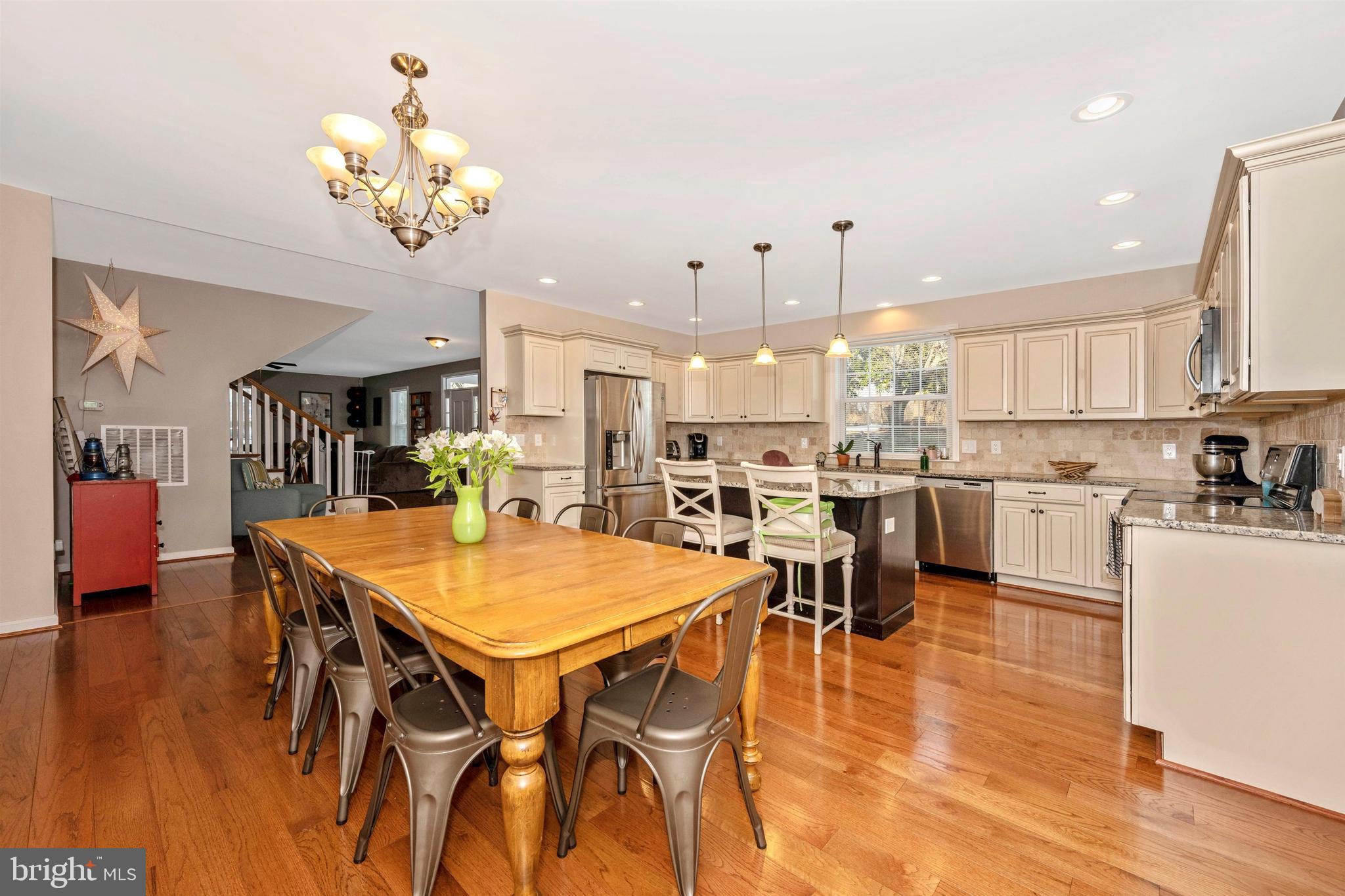 12529 Fingerboard Road Monrovia, MD 21770 - Photo 10 of 55 a view of a dining room and livingroom with furniture wooden floor a chandelier