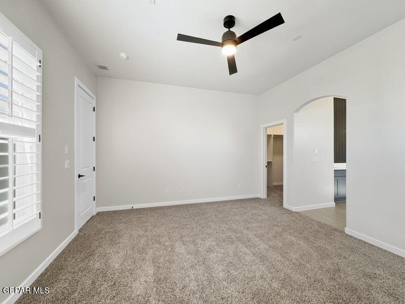 7248 Cimarron Rim Drive El Paso, TX 79911 - Photo 11 of 48 an empty room with ceiling fan and window