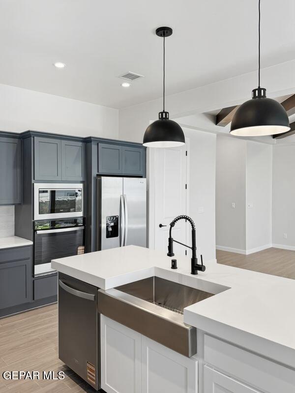 7248 Cimarron Rim Drive El Paso, TX 79911 - Photo 15 of 48 a kitchen with a sink a stove and refrigerator