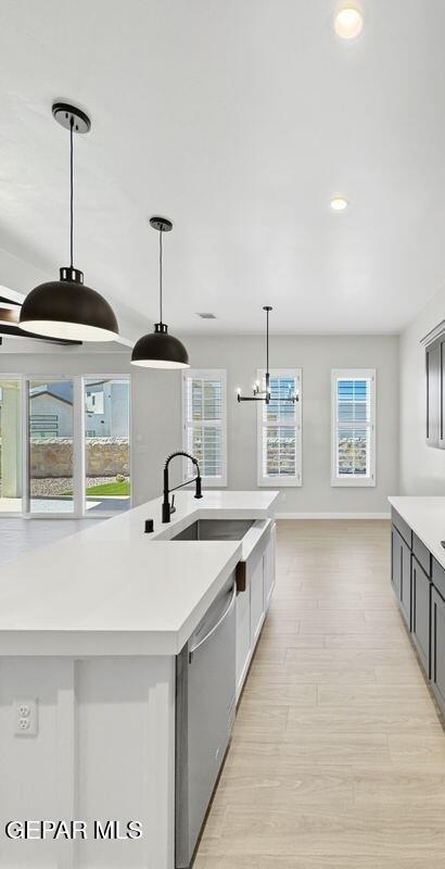 7248 Cimarron Rim Drive El Paso, TX 79911 - Photo 20 of 48 a kitchen with stainless steel appliances granite countertop a sink a stove and a wooden floors