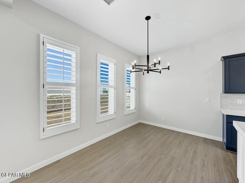 7248 Cimarron Rim Drive El Paso, TX 79911 - Photo 26 of 48 a view of empty room with wooden floor and ceiling fan