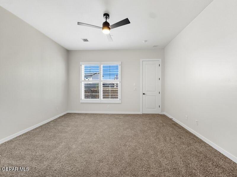 7248 Cimarron Rim Drive El Paso, TX 79911 - Photo 10 of 48 an empty room with windows and ceiling fan