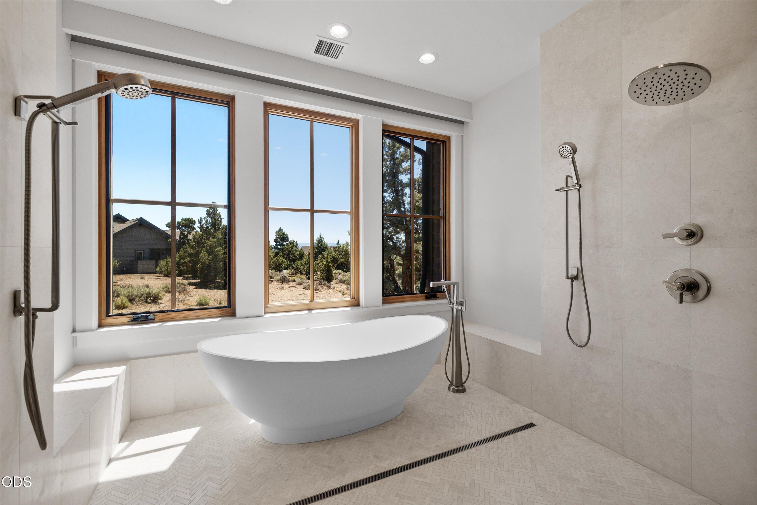 16215 South W Vaqueros Way Powell Butte, OR 97753 - Photo 19 of 48 Glass-enclosed wet room features a multi-head shower system and deep-soaking tub for a spa experience