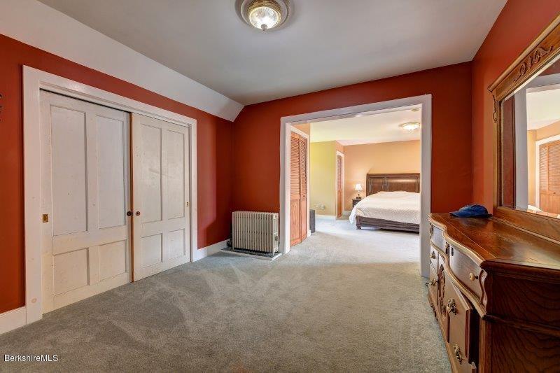 188 Huntington Road Worthington, MA 01098 - Photo 21 of 37 a bed room with a bed and a large mirror
