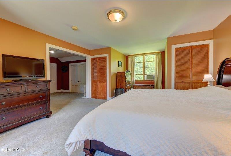 188 Huntington Road Worthington, MA 01098 - Photo 23 of 37 a bedroom with a bed and a flat screen tv