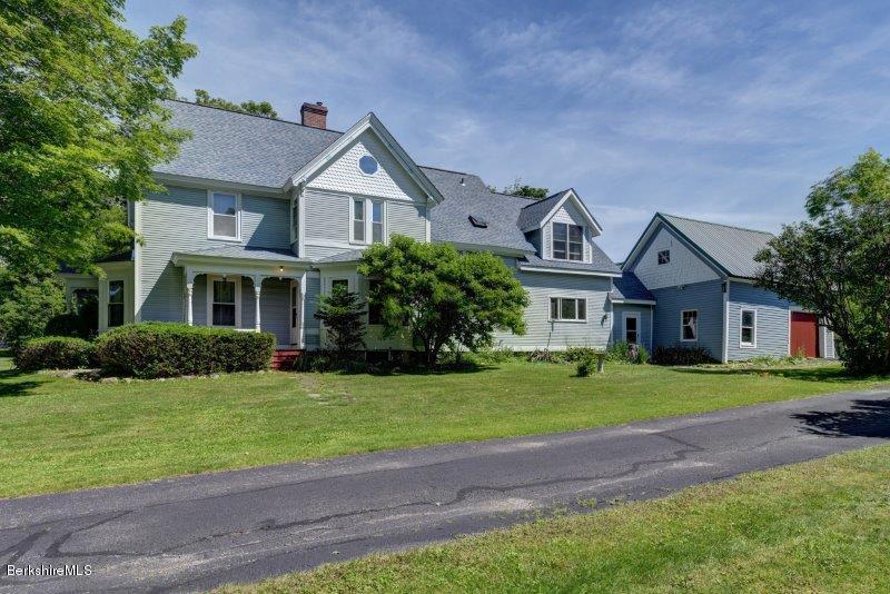 188 Huntington Road Worthington, MA 01098 - Photo 5 of 37 a front view of a house with a yard and garage