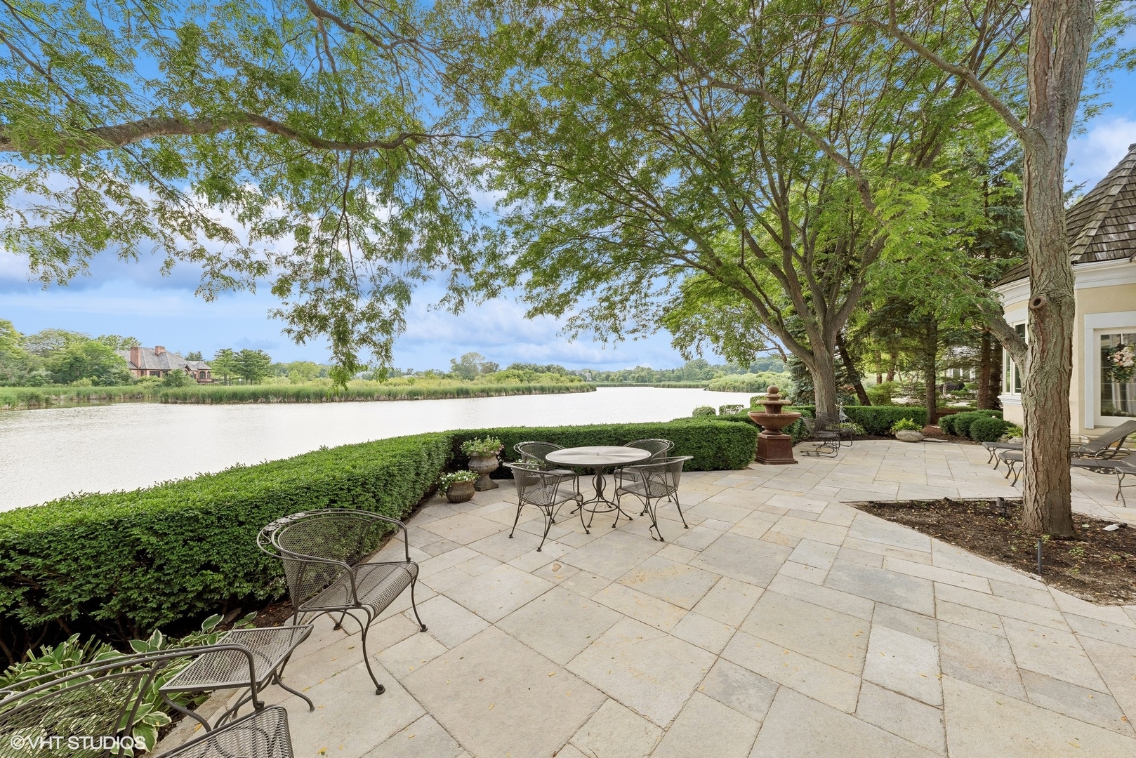 31 Riderwood Road North Barrington, IL 60010 - Photo 29 of 35 a view of a lake with a table and chairs under an umbrella
