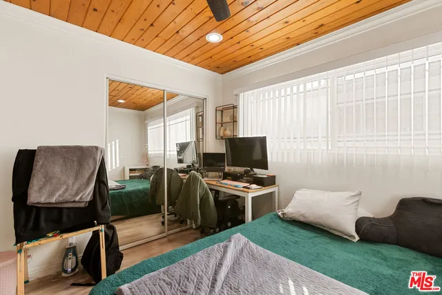 a bedroom with furniture and a flat screen tv