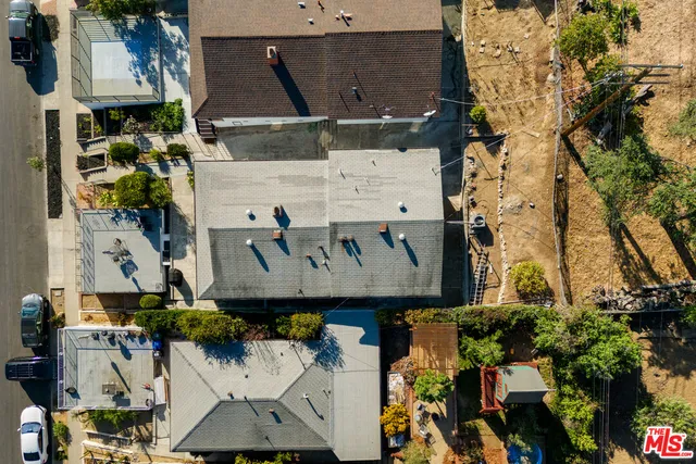 an aerial view of residential houses with outdoor space