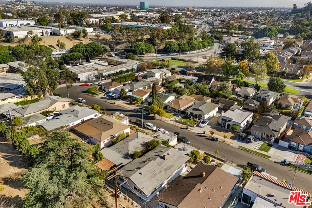 an aerial view of residential building with parking