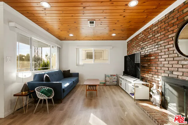 a living room with fireplace furniture and a flat screen tv