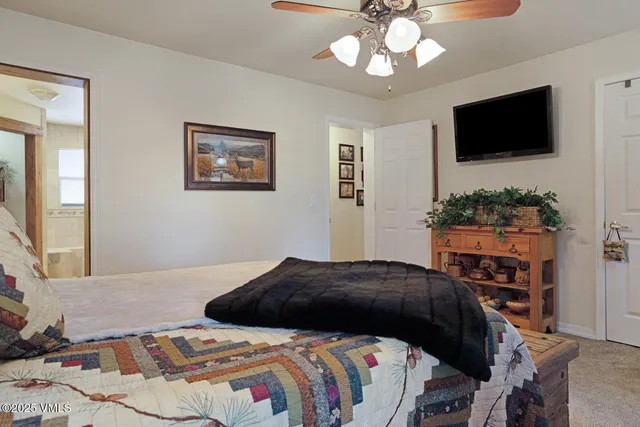a bedroom with a bed window and a flat screen tv