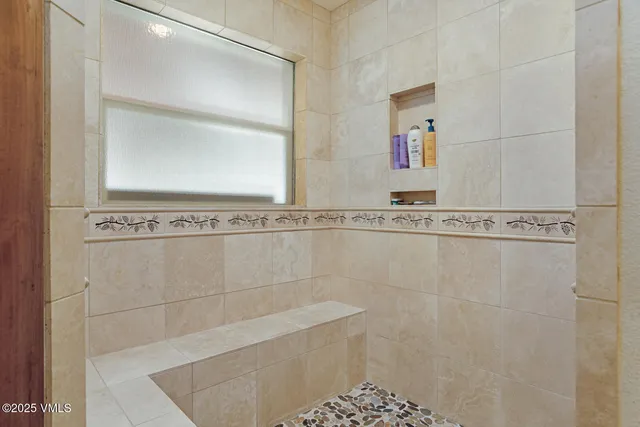 a bathroom with a shower and a sink