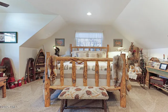 a bedroom with furniture and a large window