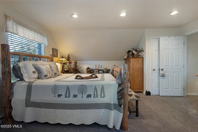 a bed sitting in a room next to a window