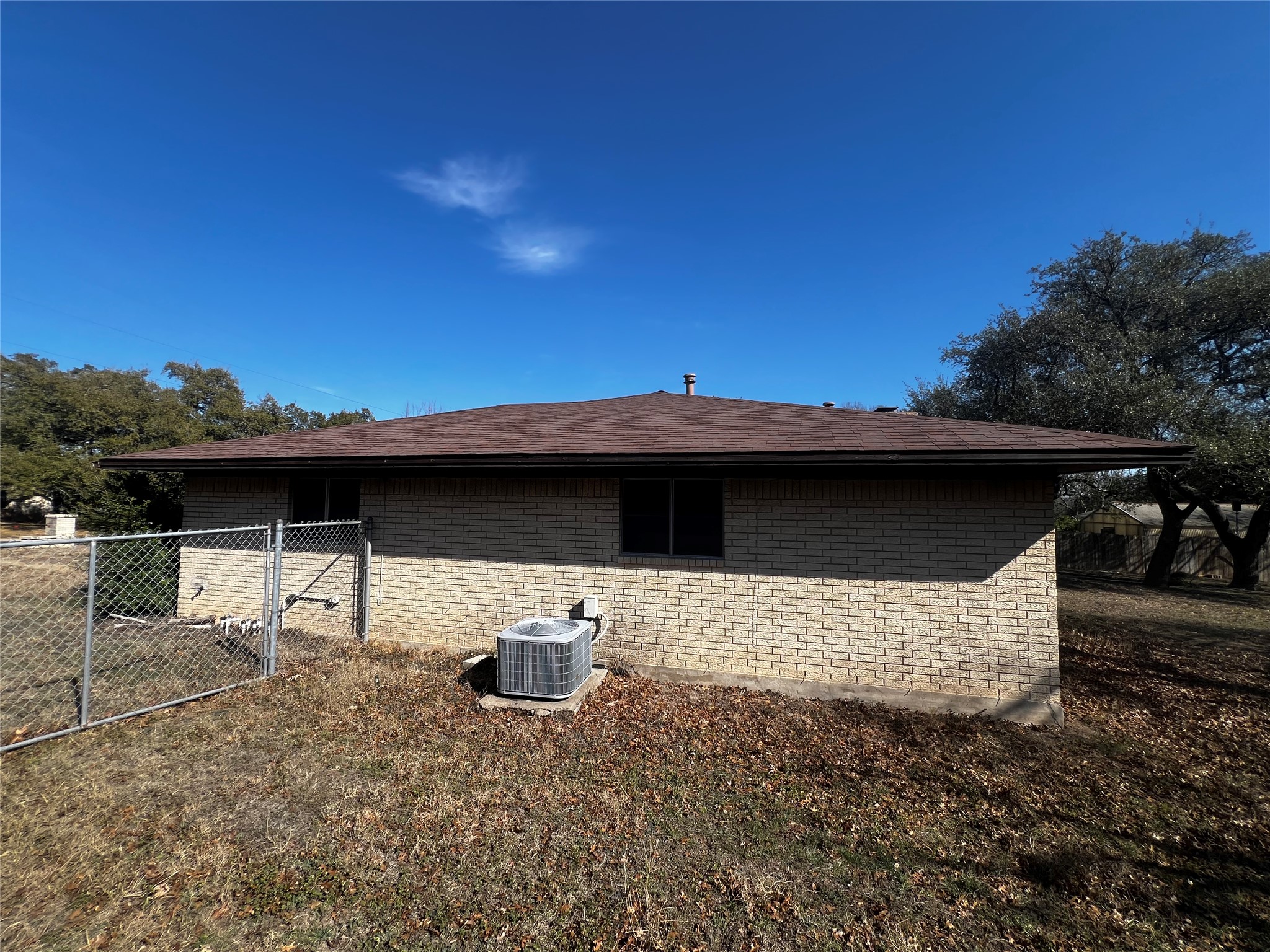 1302 Oak Shadows Circle Austin, TX 78758 - Photo 4 of 34 View of home's exterior right side, features a gated back yard entry.