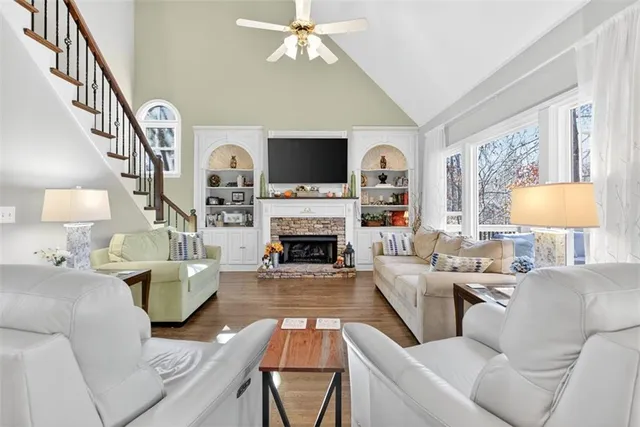 a living room with furniture a fireplace and a flat screen tv